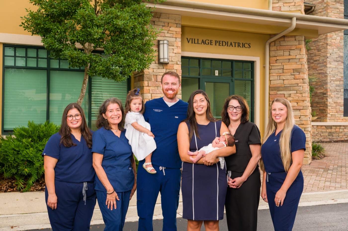 The Village Pediatrics provider team with Dr. Dupont's family outside our St. Augustine office